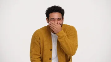 Shot of the sample: the man covers his mouth and laughs
