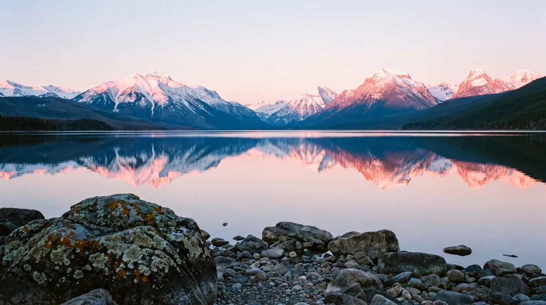 Wide mountain lake at sunrise reflecting snow-capped peaks, a 4K large-format landscape