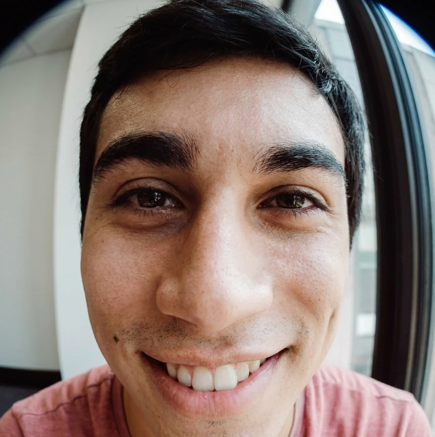 Fisheye effect selfie cropped to the face for a round profile picture, with curved edges still visible